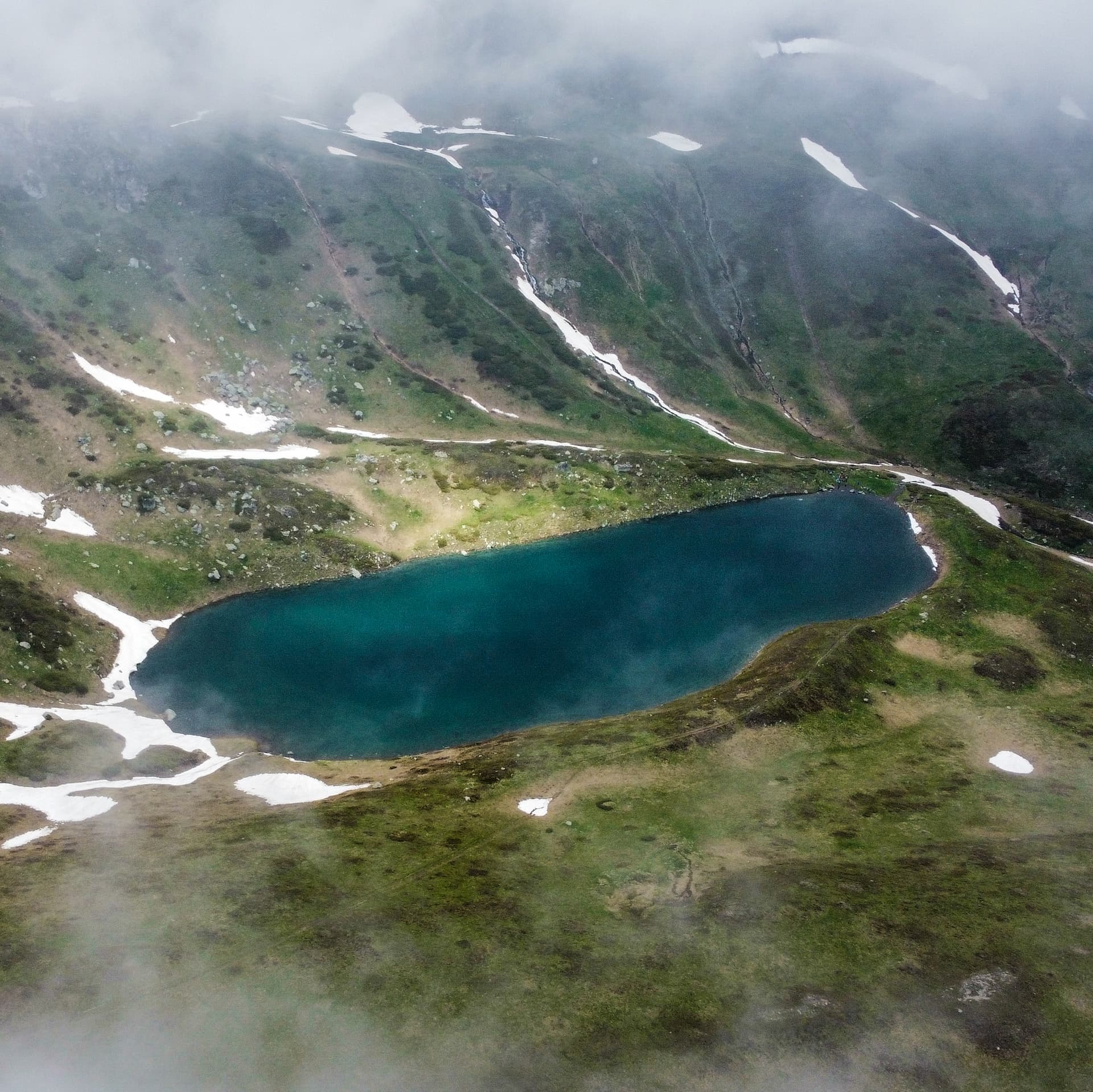Travelers looking over a mountain landscape in the Balkans